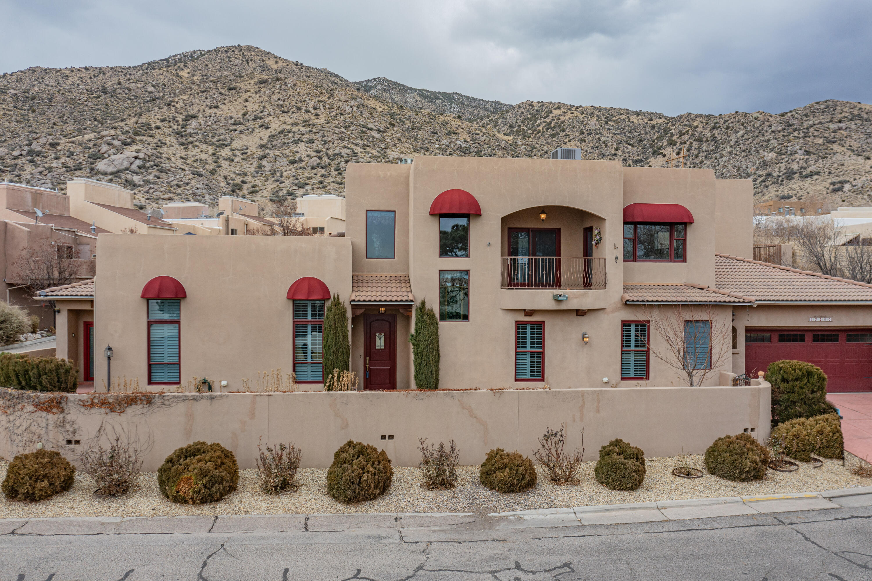 Gracious living in the Foothills! Custom Tuscan Villa style townhome with upgrades throughout. Home is attached to only one other unit at the back. The low maintenance front yard is the only space you'll have to care for! First floor primary suite with luxurious bathroom with high end Onyx tile throughout and a large walk in closet. Large living space with hardwood floors plus a lovely breakfast room or office. Gorgeous chandeliers and high end lighting throughout. Plenty of storage upstairs and down and an oversized garage. Fabulous curb appeal with custom red garage door and red awnings. The location can't be beat with easy access to the foothills trails.