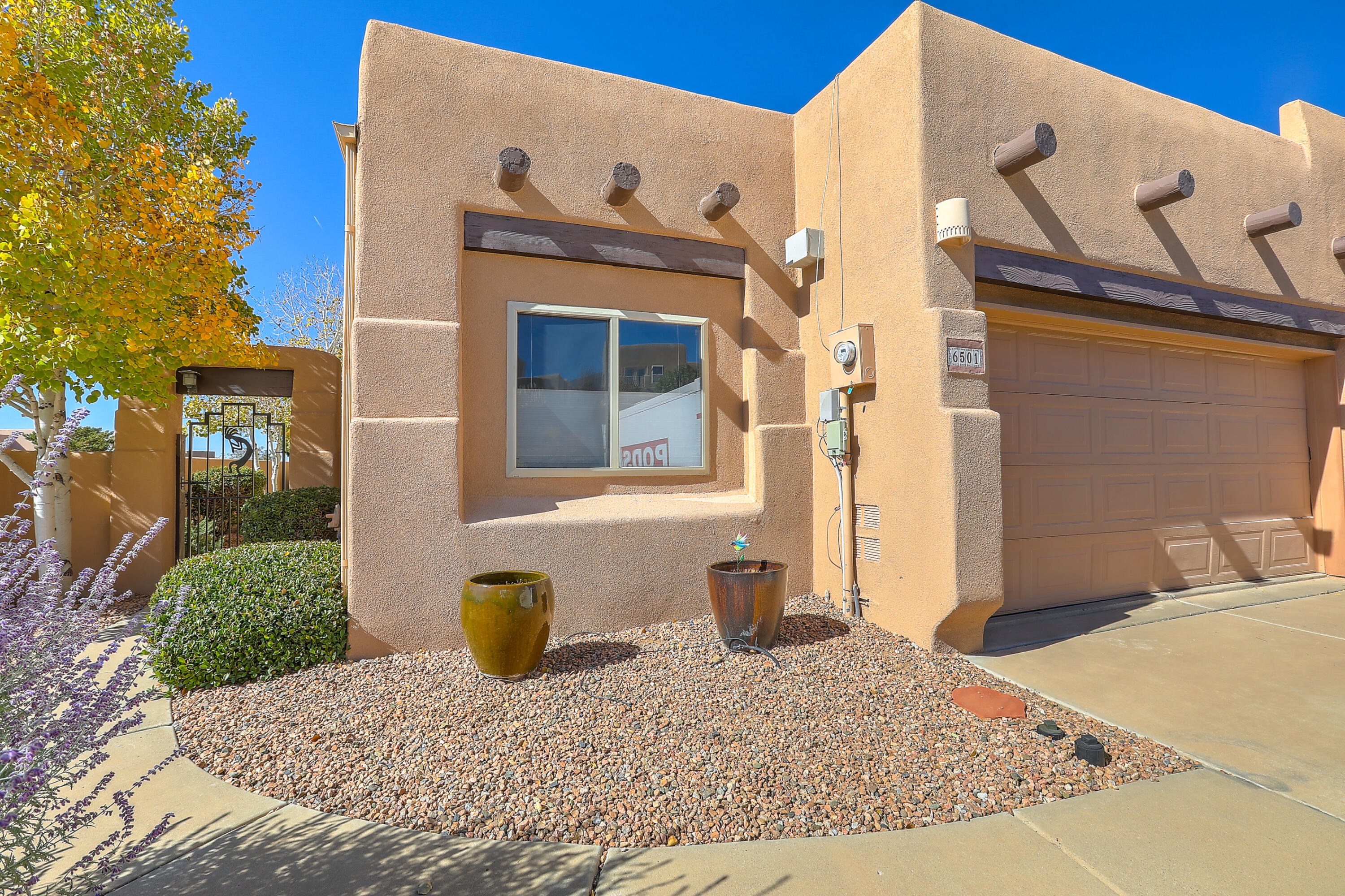 Stunning townhome located in The High Desert. With 3 bed, 2 bath, and a 2-car garage, this home offers ample space. The property spans 1,834 square feet and exudes exceptional quality throughout. One of the standout features of this home is the abundance of natural lighting and open floor plan. The great room is a highlight with a beautiful Kiva fireplace, decked ceilings adorned with vigas, and block windows. The kitchen is a chef's dream, plenty of cabinet space, vaulted ceilings, skylights, extra-large island and pantry. The lush landscaping adds to the appeal. Enjoy breathtaking mountain and city light views from the property. Recent updates include: new water heater 2019, new roof 2019, new skylights 2019, new dishwasher 2020, new stucco 2020. Schedule your showing TODAY!