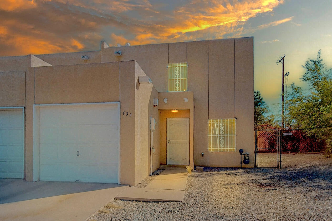 Welcome home to this adorable 2-story townhome with a prime location near Kirtland Air Force Base and Sandia Labs. This charming residence features a thoughtfully designed open-flowing floor plan that maximizes space and functionality, creating a welcoming ambiance with high ceilings, two spacious bedrooms, beautifully remodeled bathrooms, and an oversized one-car garage. The sun-filled kitchen offers a breakfast bar and nook. Throughout the home, inviting improvements include new flooring, refreshed paint, stylish light fixtures, baseboards, and evaporative cooling. The house is on a large corner lot, providing extra space for gatherings and the potential for backyard access. Convenient location and close to shopping, eateries, and more