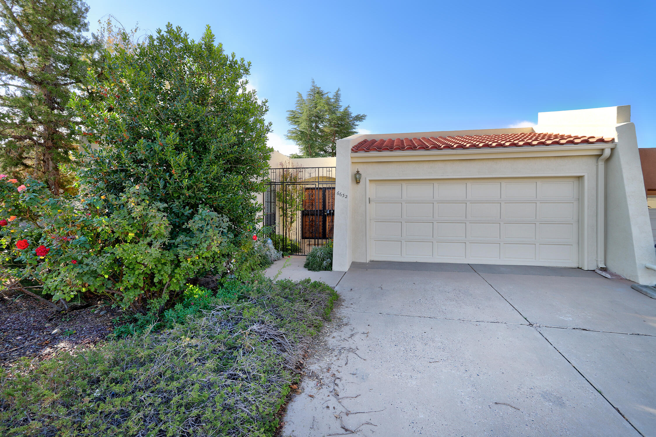 Gracious single level Mossman townhome! No HOA fees! Refrigerated air, parquet floors and tile floors, wood-burning fireplace, 2 living areas.  Sun filled skylights make this home bright and cheerful.  This gem offers comfort and easy living.  Only connected at the garage on one side.  Spacious formal living and dining areas.  Breakfast area off kitchen. Three linear closets in the Primary Bedroom.  Primary bath recently remodeled.  Bill paying center or coffee bar in kitchen. The primary bedroom is roomy, with a full bath, separate shower and tub, skylight, and a window for natural light.  Great bedroom separation with 2nd bedroom at front of house.  Enjoy a covered patio with a pull down shade. Close to Whole Foods, Albq Academy, Cherry Hills library and so much more.