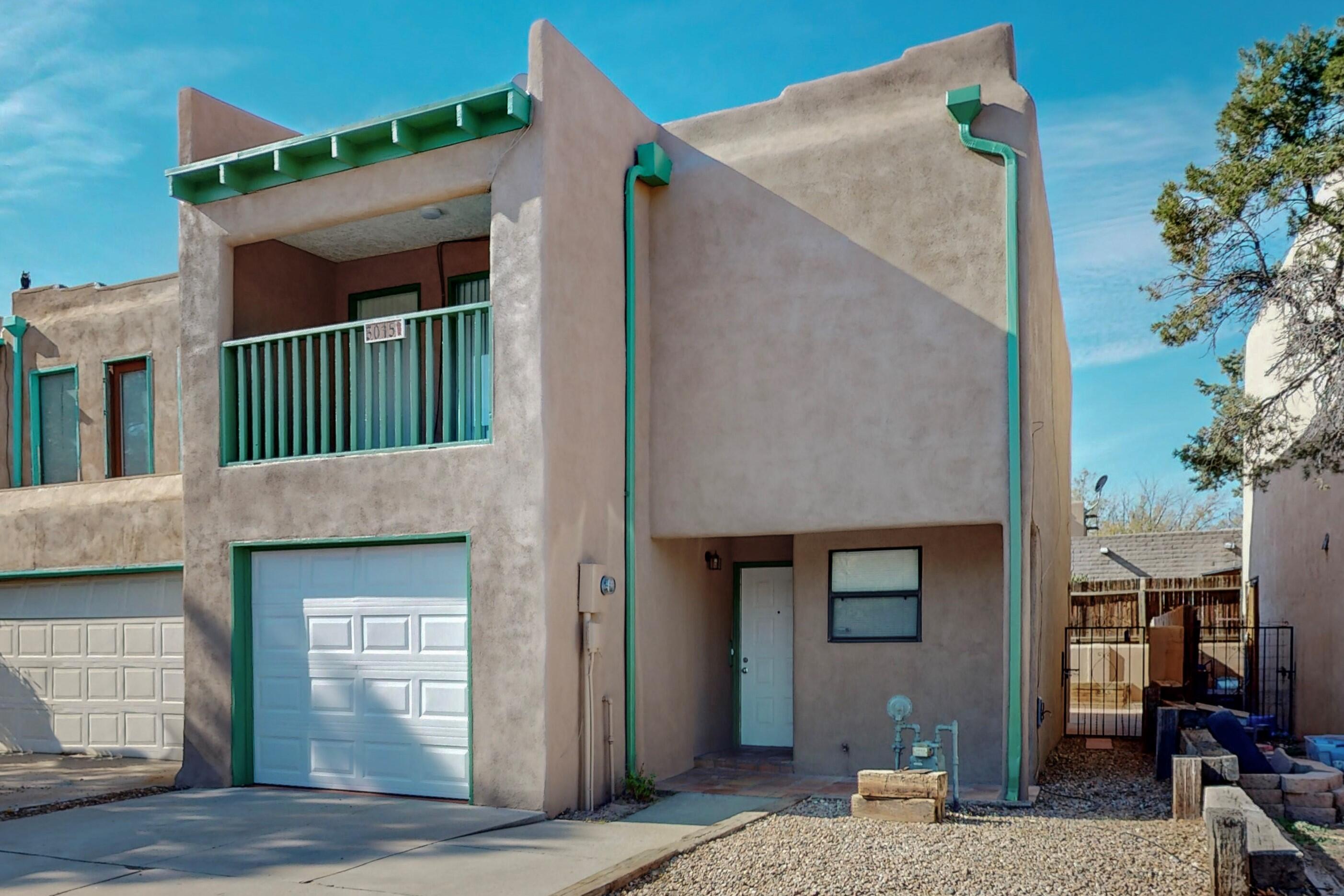Move-in-Ready Townhome. The main level features a cozy living room with wood-burning fireplace, half bathroom, and freshly painted kitchen cabinets and countertops. Saltillo tile in the kitchen, dining area, and foyer with access to the 1-car garage.  On the upper level, you'll find three bedrooms, a large laundry room, a full bathroom, and a primary suite with a full bathroom, walk-in closet, and balcony. The backyard is private and low-maintenance, with a covered patio. Recent updates include carpet, fresh paint throughout, furnace in October 2023, kitchen appliances and roof maintenance with a 1-year warranty. You'll be within walking distance of restaurants and shopping and have easy access to I-40.