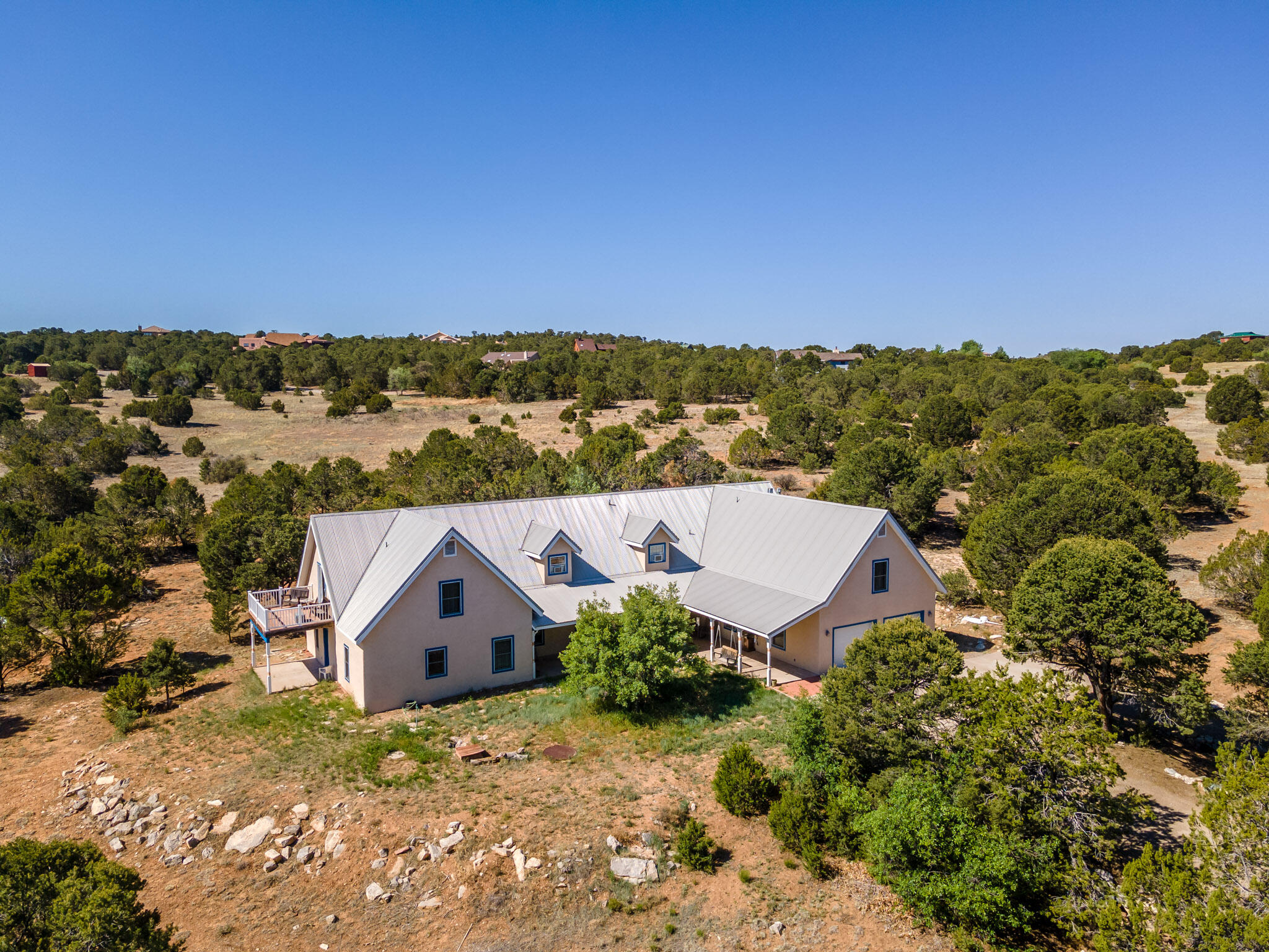 This lovely, private home on over 3 acres in gated Vista de Manana is the best buy you can get in the luxury communities around Tijeras! New stucco, plumbing and upgraded septic system in 2021, new roof in 2019; plus it's listed at over ** $100,000 below** the most recent appraisal.  Water provided by Entranosa and a smart-meter system. Plus, the charm factor is off the charts: kitchen with butcher block counters and beadboard backsplash, custom cabinetry, Talavera bathroom sinks, deep window sills for your herbs and plants, Pella wood windows. Two luxurious en-suite bedrooms on the lower level, plus two (or more!) bedrooms upstairs, with options for painting, writing, home theater, studio, games, gym, guest quarters, classroom. So many possibilities! Experience rainstorms from...