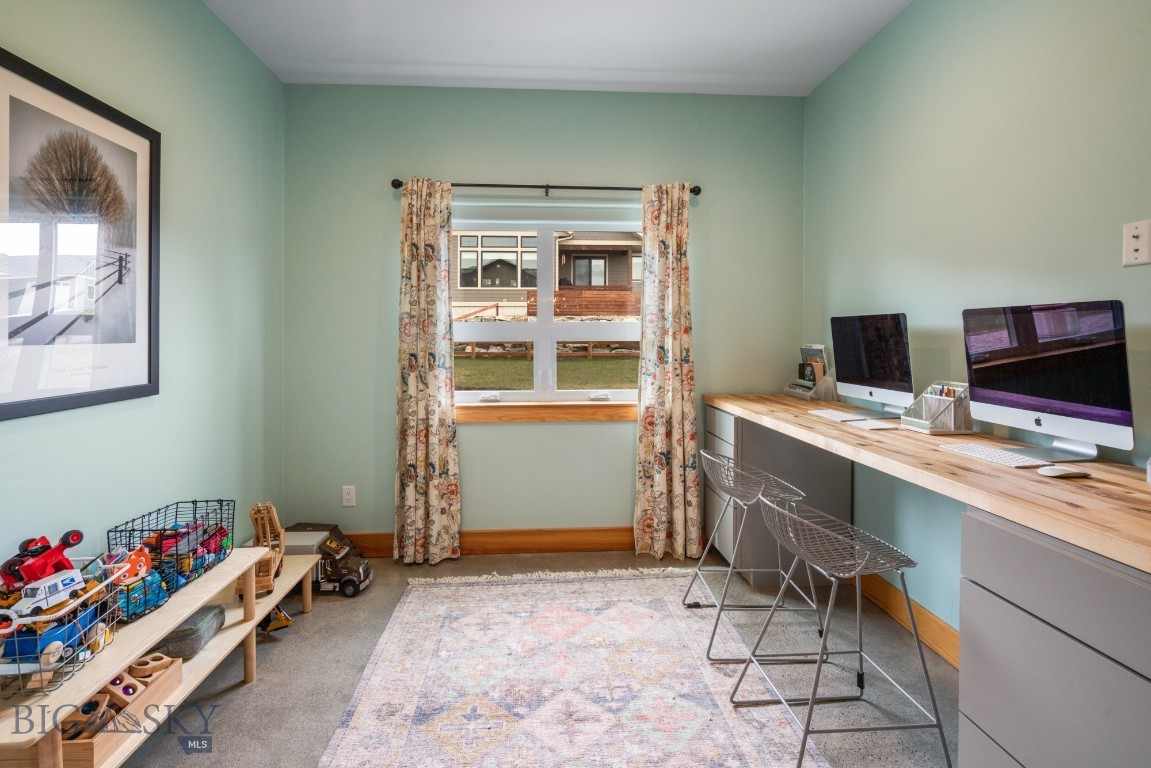 Flexible home office space with alder wood barn doors for privacy.