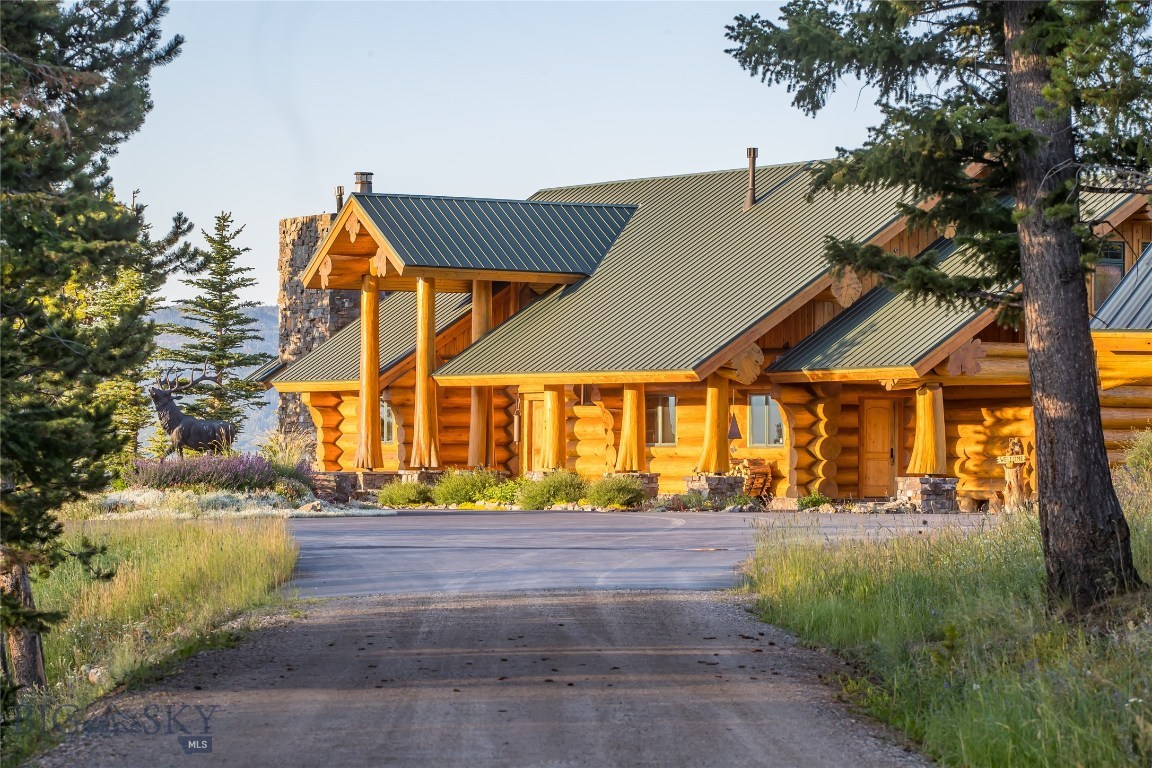 This very private luxury home on 171 acres is a recreational paradise set in one of the most beautiful locations on earth, surrounded by three majestic mountain ranges. The exquisite custom log home was built of Canadian red cedar & Chief Joseph rock. Expansive, welcoming spaces include massive rock fireplaces, huge windows that frame Lone Peak & the Spanish Peaks, four private ensuite bedrooms, a spacious master suite, gourmet kitchen, offices, kids bunk room, play room, family room, mud room, workout and storage rooms. A huge log deck spans the full length of the main house- perfect for entertaining & wildlife viewing. The detached 4 car garage has a 3 bedroom Guest/Caretaker apartment above. Wildlife abounds. Recreational opportunities include hunting, x country skiing, hiking, mountain biking, riding & snowmobiling. All Big Sky amenities, including skiing, shopping & dining are just a few minutes away.  This property has a conservation easement in place.