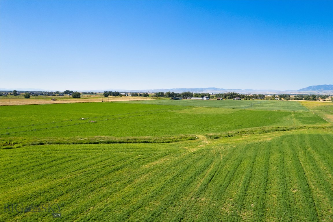Flat 57.6 acres in the path of progress.  Outstanding mountain views.  Water rights and wheel lines convey.  Currently planted in hay. McDonald Creek runs across a SE corner.  Contiguous to MLS Listing 374352