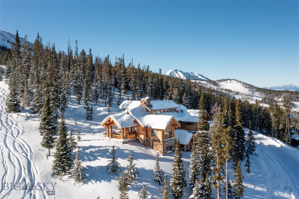 This end-of-the-road location perched on a ridgeline in Moonlight Basin provides unsurpassed privacy and the best ski-in/ski-out access in the western US. This custom Durfeld log home is meticulously nestled on 2.42  acres in an old-growth forest offering seclusion without interruption of the commanding mountain views. The interior is designed with privacy and views in mind offering 4 prime en-suite bedrooms, 2 additional half baths, two large living areas, a workout room, and a loft with a wet bar. The winter and summer recreation from your backdoor is world class with direct access to skiing/hiking/biking trails connecting to either Moonlight Basin or Big Sky Resort. Included is a Signature Membership to the private Moonlight Basin, which provides access to the Jack Nicklaus Reserve Golf Course, Moonlight, and Lake Lodges offering a variety of restaurants, spas, fitness facilities, and extensive recreational opportunities. 30 minutes to Yellowstone National Park.