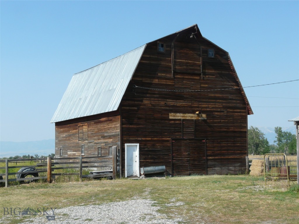 This commercial opportunity consists of an older single level residence that is currently rented month to month on ten productive acres with long frontage on Hulbert Road and just off  State Highway 191. There is also a historic barn that could be converted to an event venue , possibly relocated, or salvaged for rustic lumber and timbers. Commercial development is occuring on Highway 191 in both directions and moving towards this property. There is also a large gravel extraction operation East of the property on Hulbert Road.