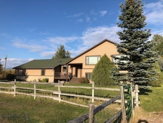 This spacious custom built trilevel set on 5.5 acres can be your new home for family ,pets, and livestock. The spacious 4 bedrooms and 3 baths has room for everyone, with multiple living areas and a great trilevel floor plan . The home is sited perfectly in the middle of the 5 acres , providing plenty of privacy from the paved road, a big landscaped lawn area, and multiple pastures for equestrian companions and 4H critters. The outbuilding  is  28 X 60  and set up with three stalls, tack room , hay storage, lawn & garden storage and extra single car garage space. There is a large covered deck for outdoor entertaining, a dog house and kennel that convey, and new fence railing. Mature landscaping provides privacy from neighbors and only enhances the panoramic views of the mountains. The location can't be beat.. just minutes from downtown Bozeman or Belgrade, Costco, Billings Clinic, the airport, and Bar3 BBQ and paved road every inch of the way.