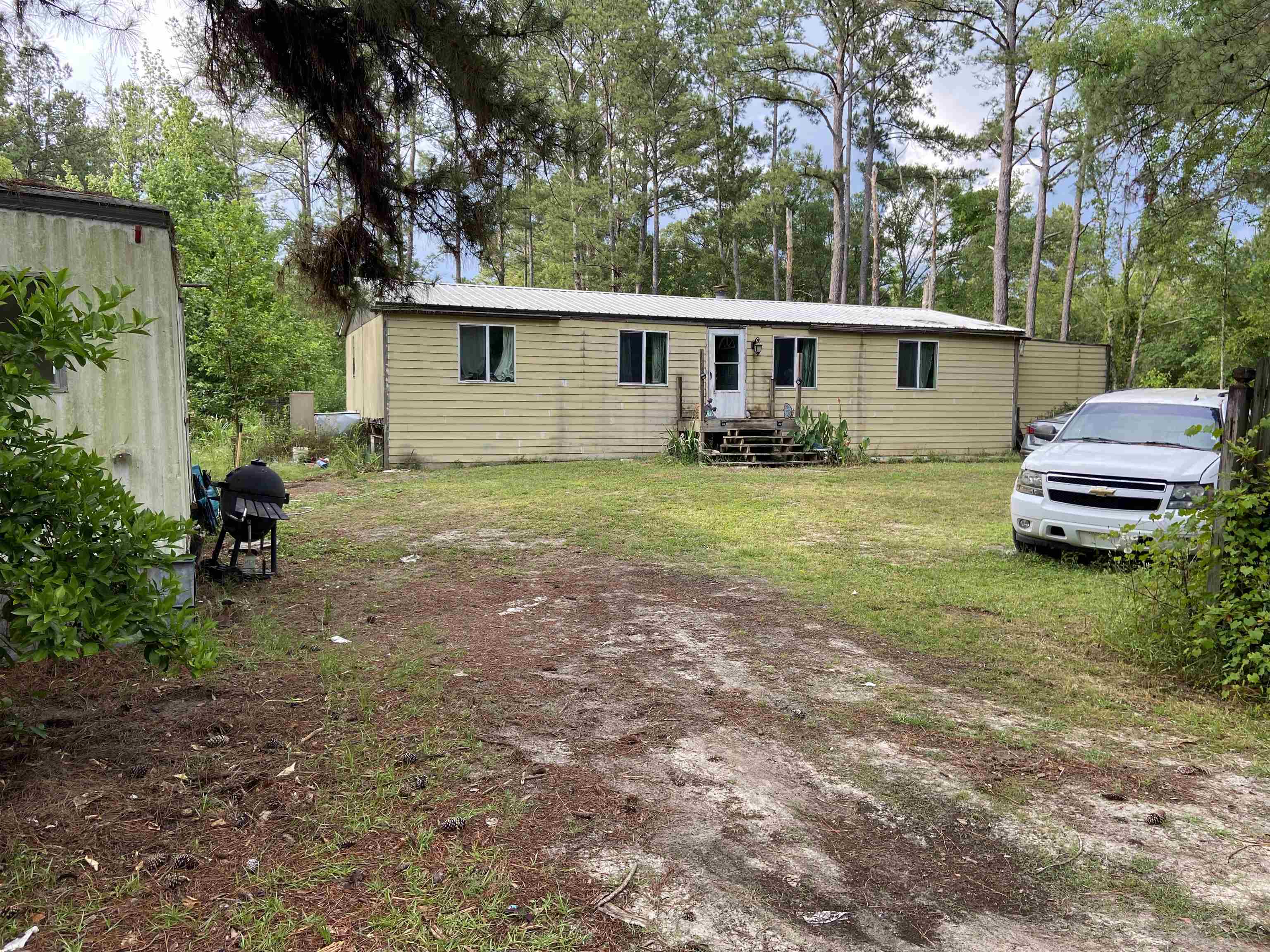 Great corner lot. Home is in need of repairs- A/C, ceiling, flooring, drywall... Property has access to pond. Fruit trees on the property include: apple, orange, kumquat, and limes! Large Work shed in the back.