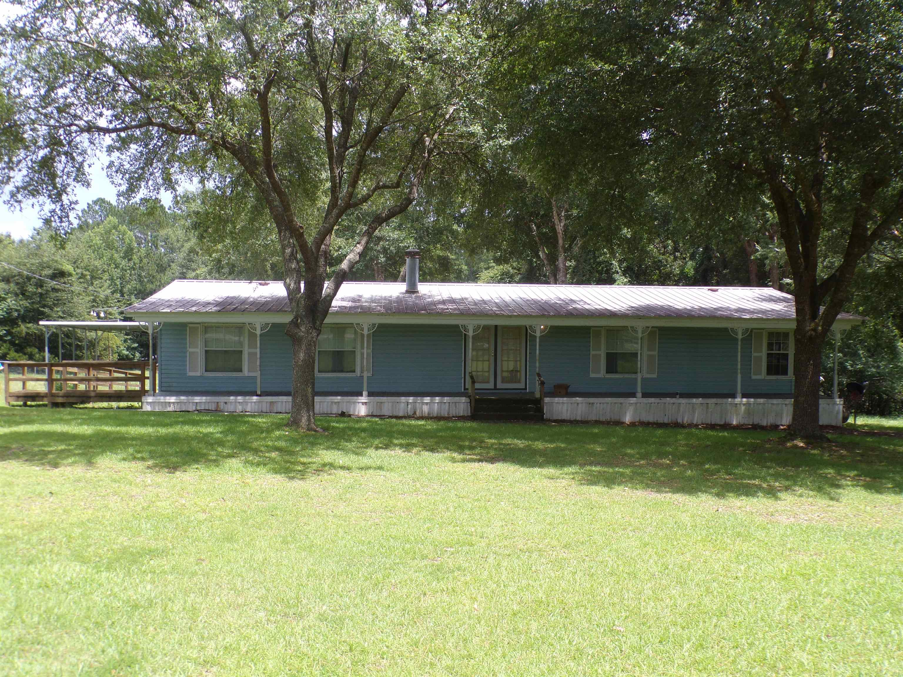2+ acres in quiet and peaceful Havana, FL.  This 3 bedroom, 2 bath double wide mobile home is set up in Scott Plantation.  The roof is approximately 8 years old, standing seam, large front and back porches and a wheel chair ramp, too.  There is a 36x36 concreted shop with walk in cooler and smoke house.  The kitchen has recently been updated with new cabinets and appliances.  Home could use a few cosmetic touches here and there but for the most part, its ready for the perfect homeowner!