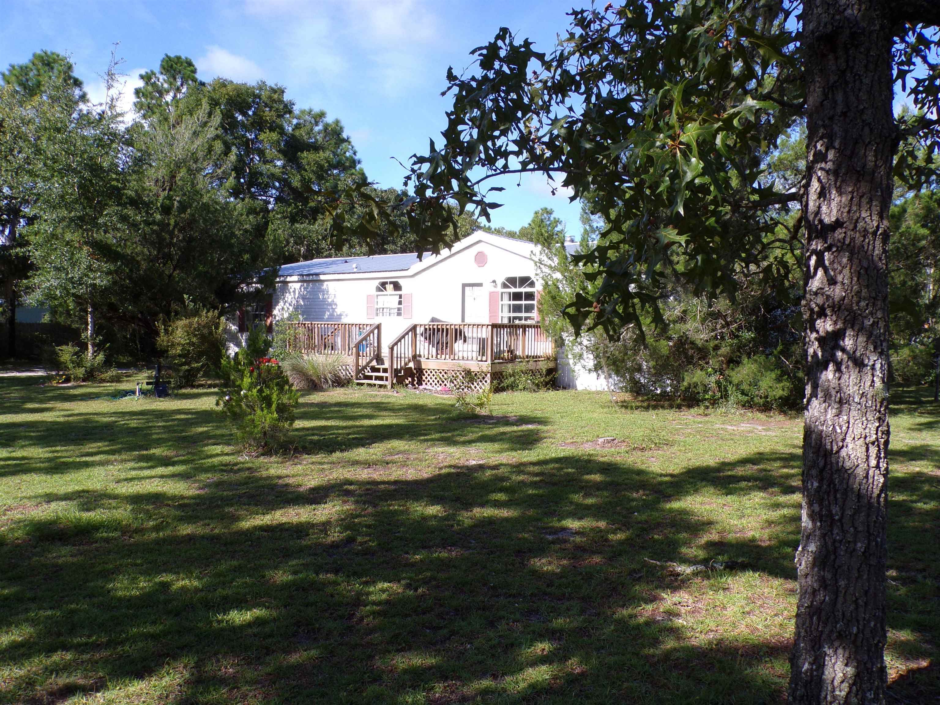 1999 Mobile Home (1998 according to property appraisers site) in Panacea, FL.  Big and spacious, 3br, 2 bath.  Roof replaced in 2019.  Home does not have central heat and air but seller is allowing up to $10,000 in repairs to include but not limited to replacing or repairing the unit prior to closing.  Mobile home is on 1 acre of land, partially fenced, peaceful & quiet neighborhood.  Approximately 30 miles to Tallahassee & 12 miles to the beach! Home uses a septic tank and utilizes county water.
