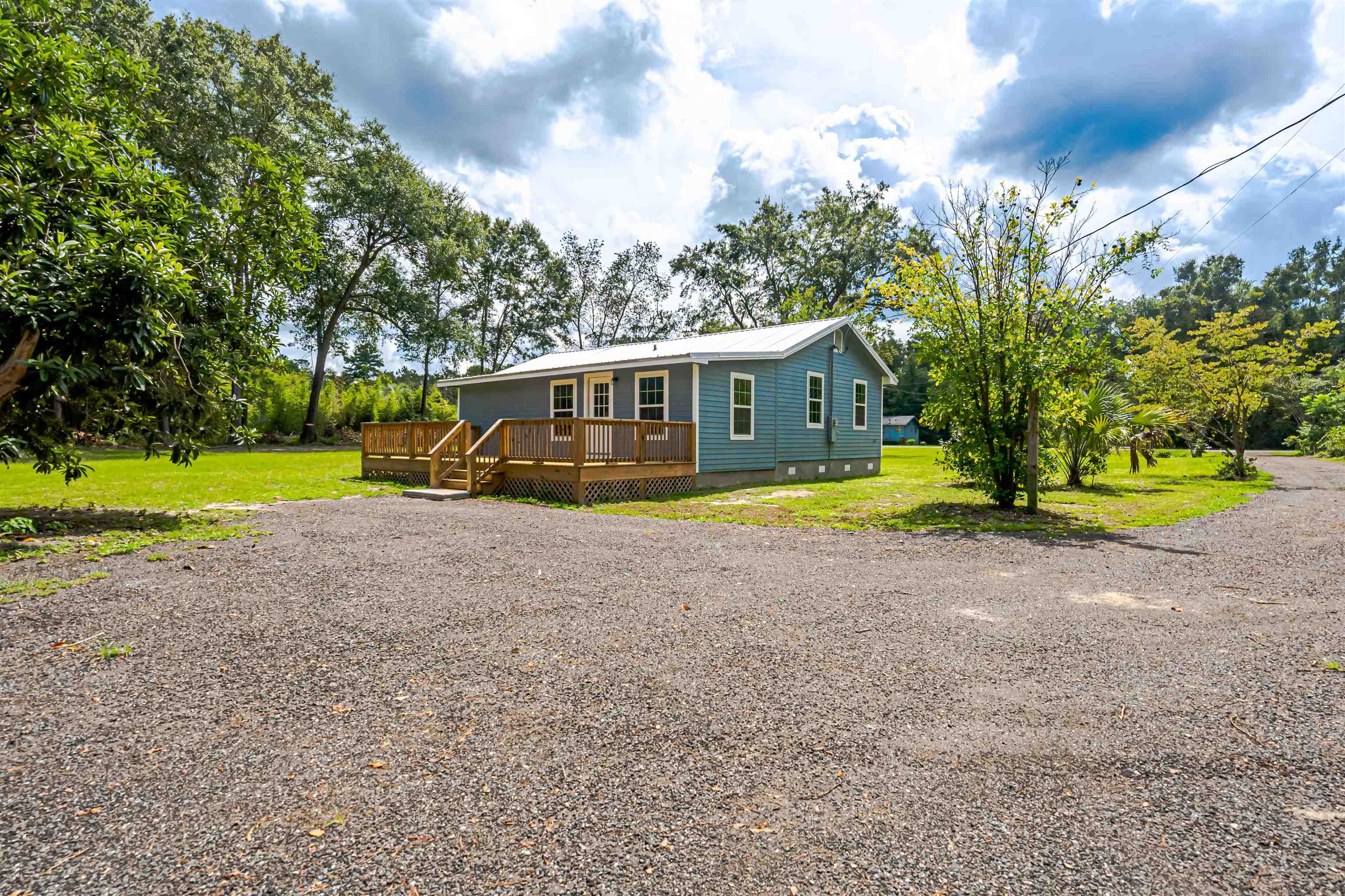 This Three-bedroom and two-bathroom home was built in 1982, but recently has been updated and boasts clean lines. Located in the Havana area just minutes from Tallahassee. This cozy home has a large back porch where you can sit and relax after a busy day, and inside, the open design is sure to make family time quality time. The kitchen has all updated whirlpool appliances and granite countertops and is very spacious for hosting your family events. This luxurious home features impeccable finishes throughout, from beautiful flooring to an amazing master bathroom. The updated interiors feature a soft monochromatic palette and clean lines. The large green 1.8 acres is great for hosting parties or family events there is a great spot to install a pool. If quiet country living is what you need without any inconvenience well this is your home!
