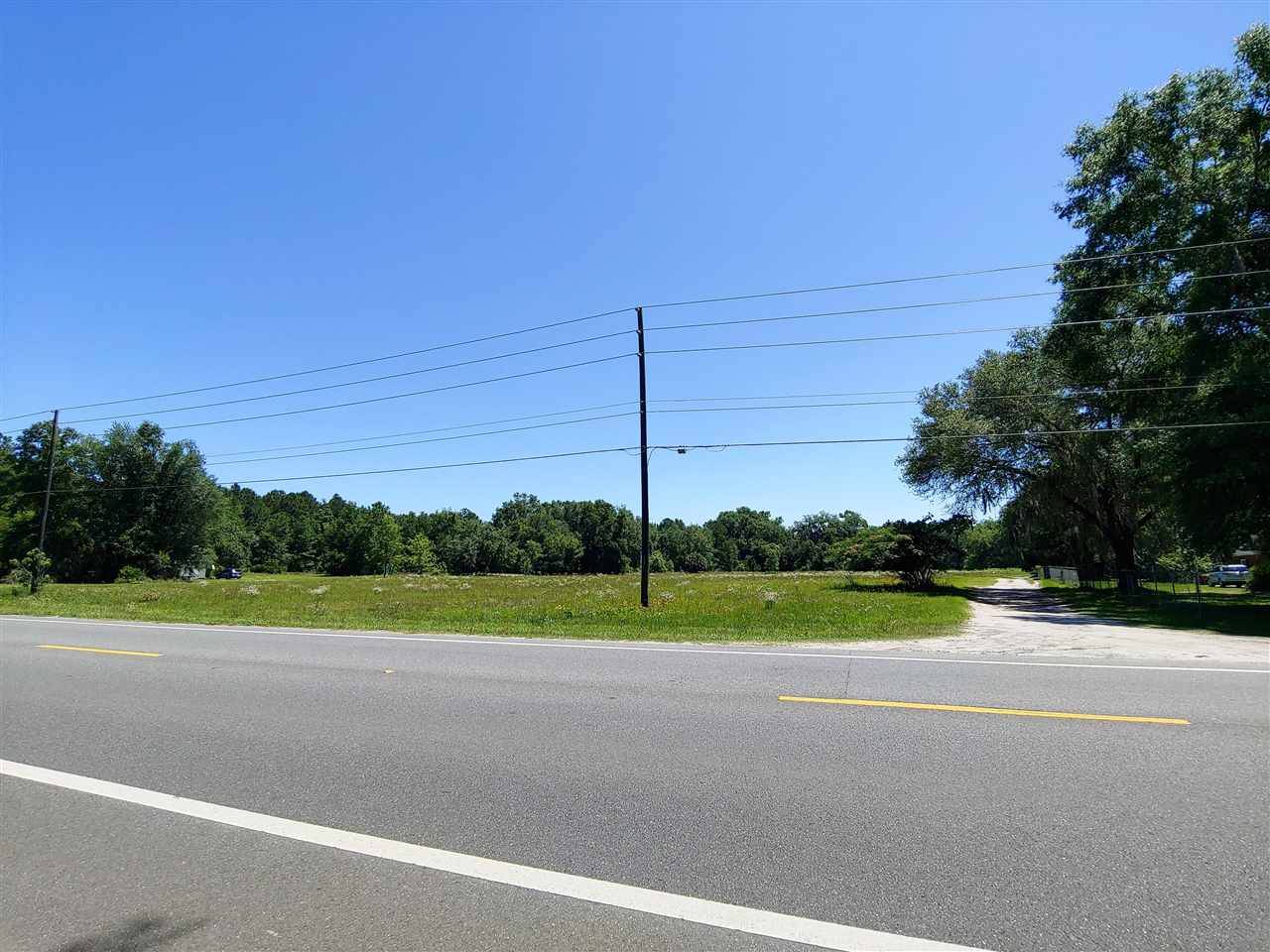 This 2.29 acres will be divided out of the current 4.29 acre parcel and will be the front portion of the current parcel which has 340 feet of road frontage on N US Hwy 221 and will be approximately 300' Deep. There is a 30' Easement on the Southern Boundary. This acreage is cleared and has established grasses.  This property is located next to the Graves Drive-In Restaurant.  Property is Zoned Mixed Use - Urban Development. Must get permission before walking or driving on the property.