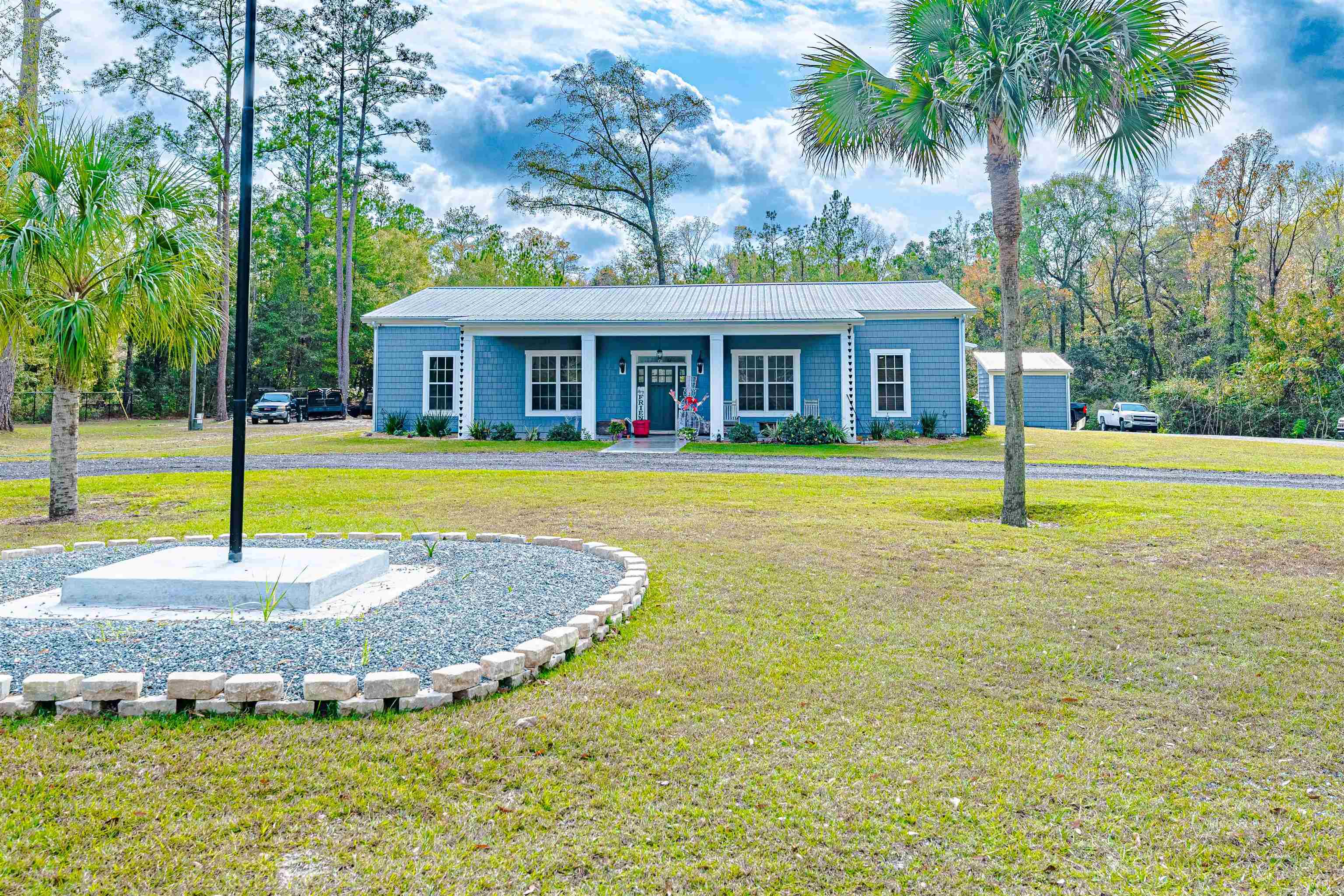 Check out this beauty in the Historical District of Gadsden County! This luxury home was built in 2021, comprised of custom features sure to peak the interest of many! From the over sized doors imported from Germany to the 1/2 inch Fiber Cement Cedar Shake Siding, from South America, wrapped around the house and 40x60 pole barn, this property is certainly one to be desired! This home features barn doors, luxury vinyl plank flooring, tankless water heater, premier gas appliances, 24 ft living area ceiling & 12ft exterior walls, 8 zone smart HVAC systems (2), granite countertops, custom pass-thru window in the kitchen, beautiful 40 inch premier copper stove vent, and so much more. Go outside and enjoy either the front or back patio with it's graphic decorative overlay cement flooring, already equipped with TV for entertaining or just relaxing.  This home is a year old and highly maintained.  It's energy efficient and handicap accessible as well.  It is also protected with greater than 6 inches of foam insulation and is safe to stand up to extreme weather conditions, including high winds and fires due to the imported Shake Siding. If you are looking for a small town feel and a premier home, this one is a MUST SEE! This house has so much more than can be described, you have to just see it for yourself, it's truly  extraordinary!