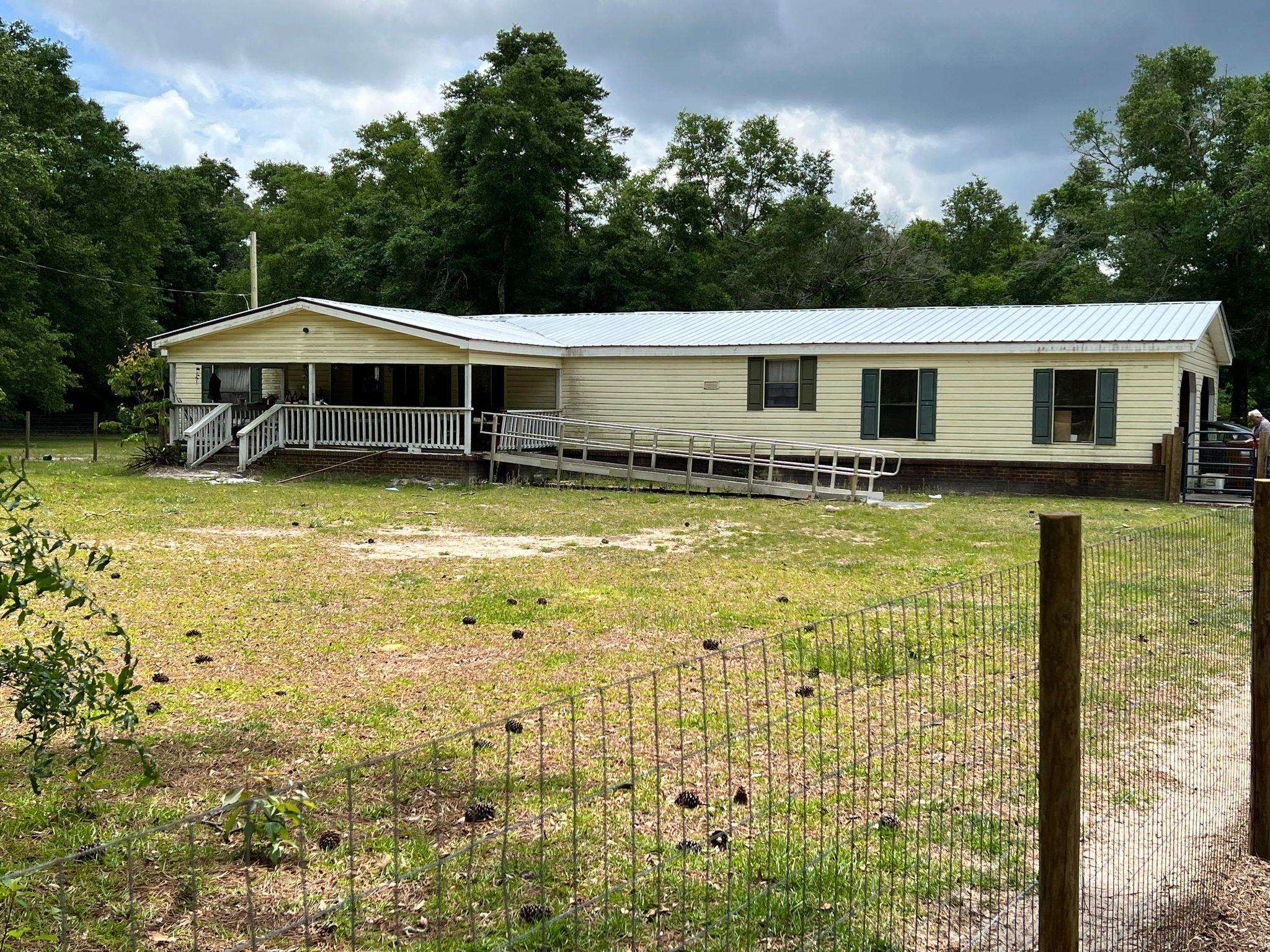Large double-wide mobile home located on Old Federal Road in Gadsden County.  9.3 acres, 2 bedroom, 2 bath.  One room was converted into a sitting room but could easily be converted back to a 3rd bedroom.  2 carport attached garage.  Floors have recently been replaced, 20-21 AC, 20-21 metal roof, 20-21 septic tank & drain field.  Front yard recently fenced.  Front & back porches for peaceful porch sitting and serenity on stressful days. Home has had a lot of upgrades.