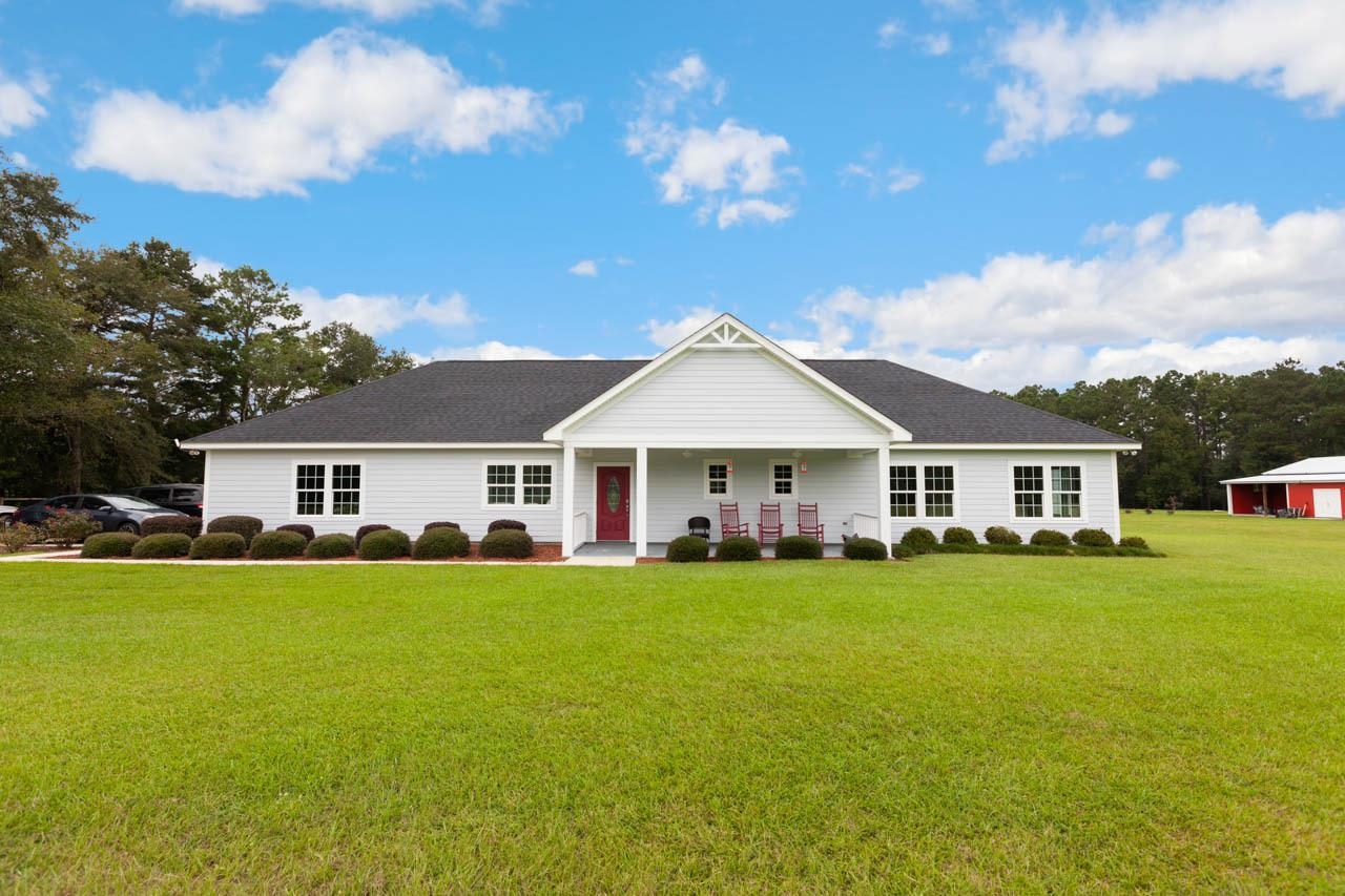 Peace and quiet at its finest! This 2018 custom 2 bedroom 2 bathroom home has all the bells and whistles. With a kitchen featuring granite counter tops with undermount sink, stainless steel appliances, ample soft close cabinet space and massive kitchen island it is a dream! The master suite sports a large walk-in closet, dual vanities, undermount sinks with granite countertop, and beautiful zero-threshold shower. With additional storage above the garage, screened patio and more, the list goes on and on. Check the associated documents for additional details. There is also a beautifully finished barn which could function as a 2 bedroom 1 bathroom in-law suite.  Sits on 20 well-cared for acres. Can be purchased as a package with 2729 Lanier Rd.