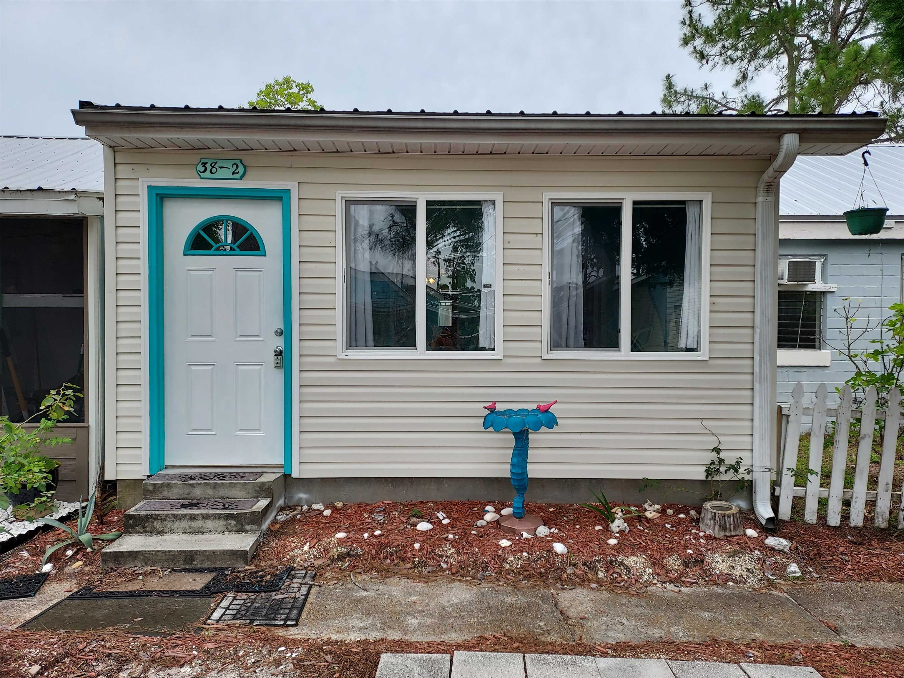 Precious Aqua Blue Beach Bungalow.  This 1 bedroom 1 bath bungalow has been completely renovated and updated. 2017 Roof, electrical, additions and plumbing. 2018 Kitchen, Appliances, Tile Floors, Paint, Hot Water Heater, Toilet and Shower Tile. This unit has a built in Laundry Closet and additional storage closet.  There is 10x9.5 Bonus Room that could be used as a bunk room, office or quiet sitting room.  Located in the quiet fishing town of Lanark Village.  This small eclectic community is great for a retirement home, vacation home, fishing villa, weekend home, primary residence or as an investment rental property. There are no HOA fees.  The local boat launch is less than 1/2 mile away and White Sandy Carrabelle Beach is a 10 minute drive.  This Forgotten Coast destination is a short 1 hour commute to Tallahassee.