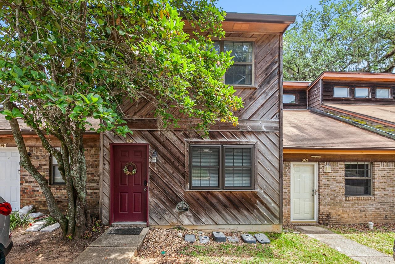 FSU Parents & Investors- ONE BLOCK to Doak Stadium! Currently a successful Airbnb tucked away in a quiet community with 2 reserved parking spaces. 2 bedrooms, 2016 reno FSU-themed bathrooms; full upstairs and half downstairs. Open living room with kitchen bar and entry onto the private back deck with wooded views. Inside washer & dryer. This very well maintained townhome, cedar sided home has new gutters, 2016 bottom windows, fridge & dishwasher. Enjoy the extra storage and spacious back deck. This is a rare find for investors and parents with this proximity to FSU and TCC. Most furnishings convey, except few linens and housewares do not. Buyer to confirm measurements. Professional photos soon.
