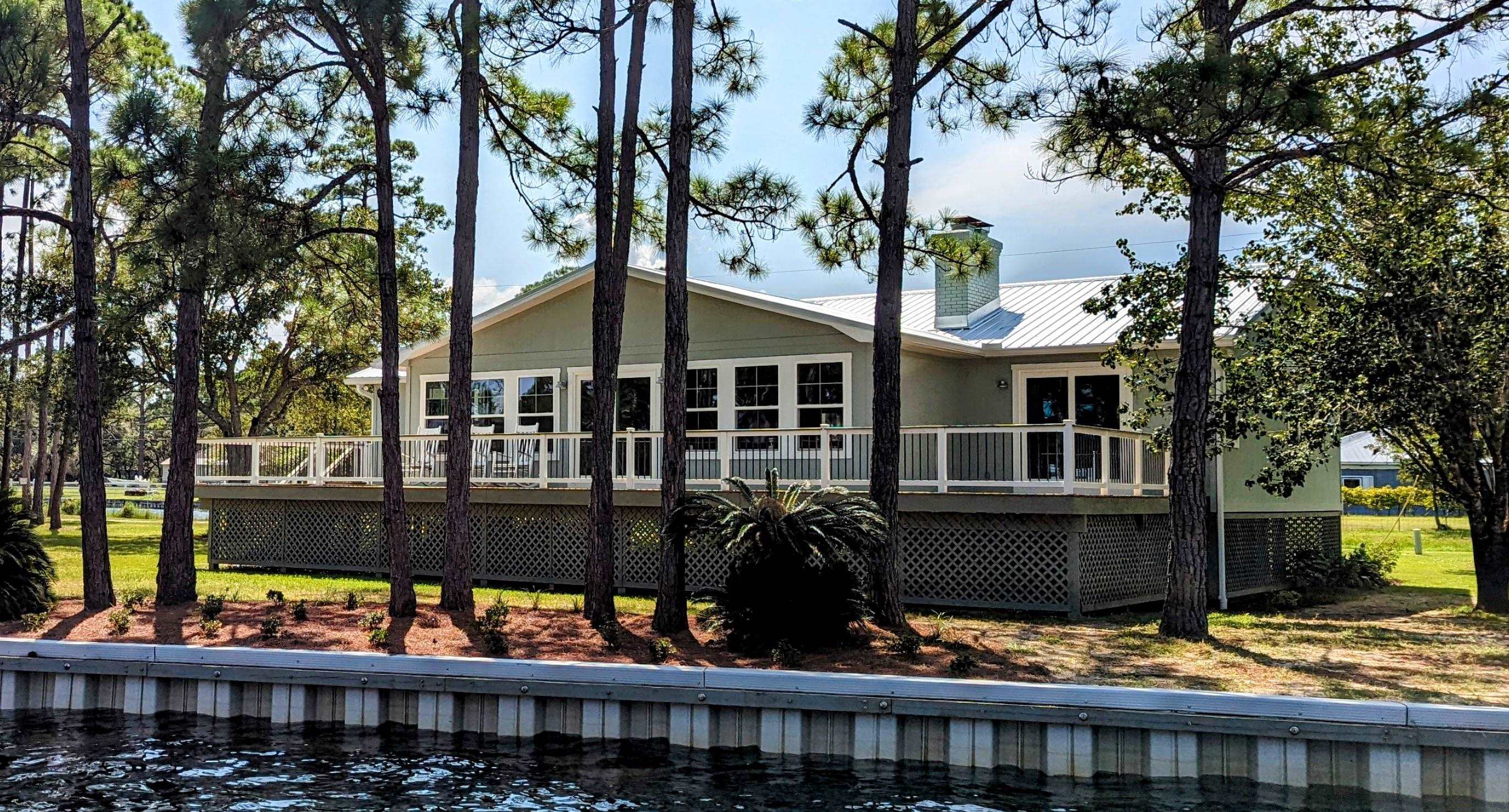 Beautiful Home on tidal canal. New 60 foot deck with views of the river. This home has been beautifully renovated.  Lots of room to entertain. Kitchen has an island with seating for 6 a beverage refrigerator and tons of cabinets.   Large main bedroom with fireplace and spa-like bathroom and walk in closet.   Pantry and laundry room with cabinets. Wood floors and tile throughout.  New roof, windows, appliances, Air conditioner, water heater. This home sits on two lots with a new 150 foot seawall.  Too many features to list them all.  Bring your bikes, boats, kayaks, and beach toys.  Lots to do in this area.  Please come by and see this lovely home.