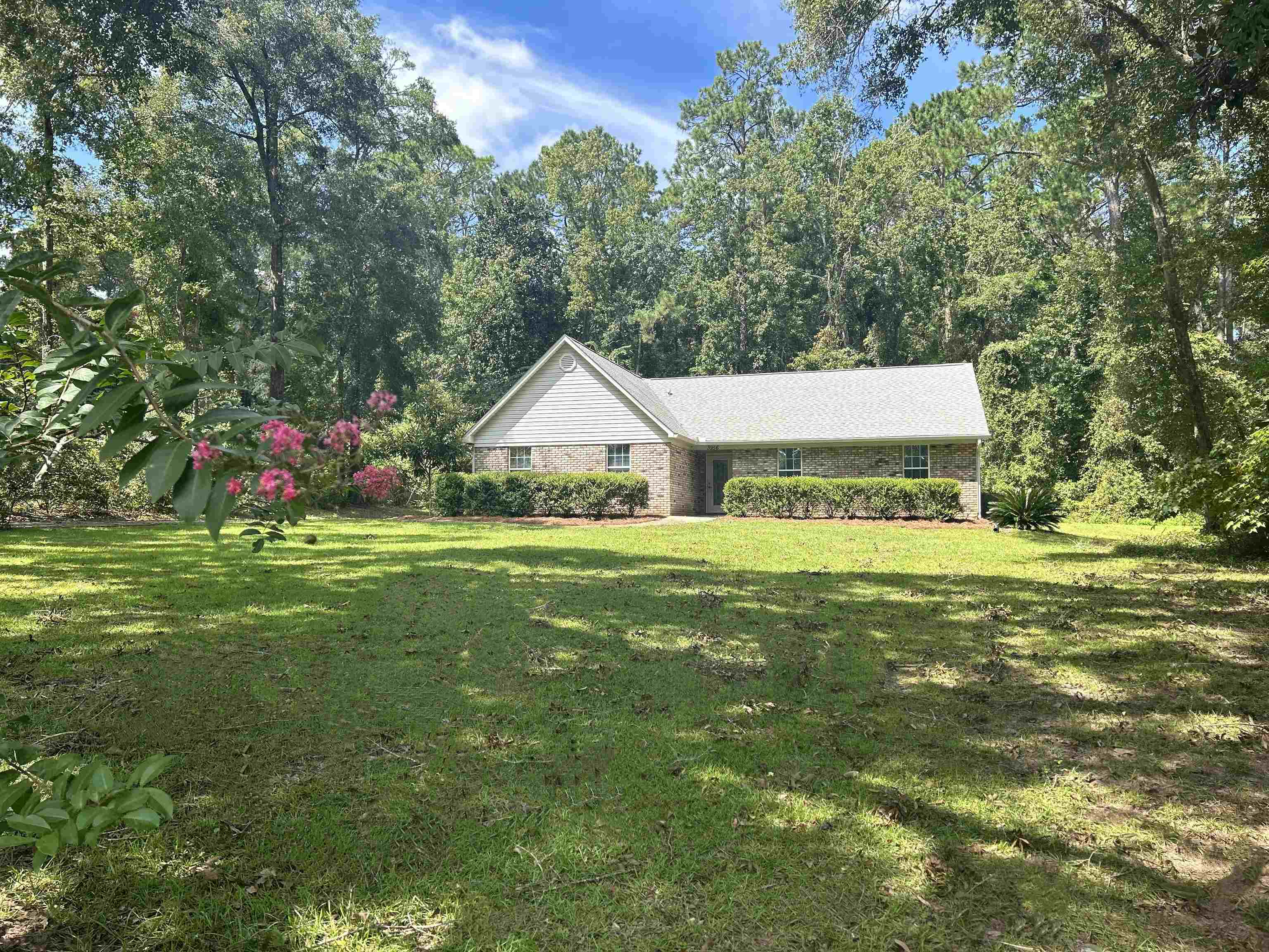 WOW! Check out this EASTSIDE BEAUTY on over half of a beautiful acre. This little neighborhood is so awesome! Tucked away off of beautiful Old St. Augustine road, one of the first highways in Florida, completed in the 1820s. It's so beautiful out here!!! Peaceful, quiet and what a scenic beautiful drive! This little gem is SO clean, and SO move in ready! HUGE family room with vaulted ceilings make this one live SO much larger. Wood burning fireplace will keep you cozy this winter. Spacious kitchen with built in wine rack. HUGE main bedroom with laminate wood flooring and walk in closet. Jacuzzi tub and separate large walk in shower in the main bath. 370 sq. ft. covered screened in porch is the perfect place to relax and enjoy your extremely private back yard. 2 vehicle or boat carport attached to a huge 23x10 wood storage shed or utility room with electricity. You can bring ALL of your toys to this one!! NO HOA!!! Back yard goes further back behind wooded buffer and carport/shed, please see attached survey for lot dimensions.