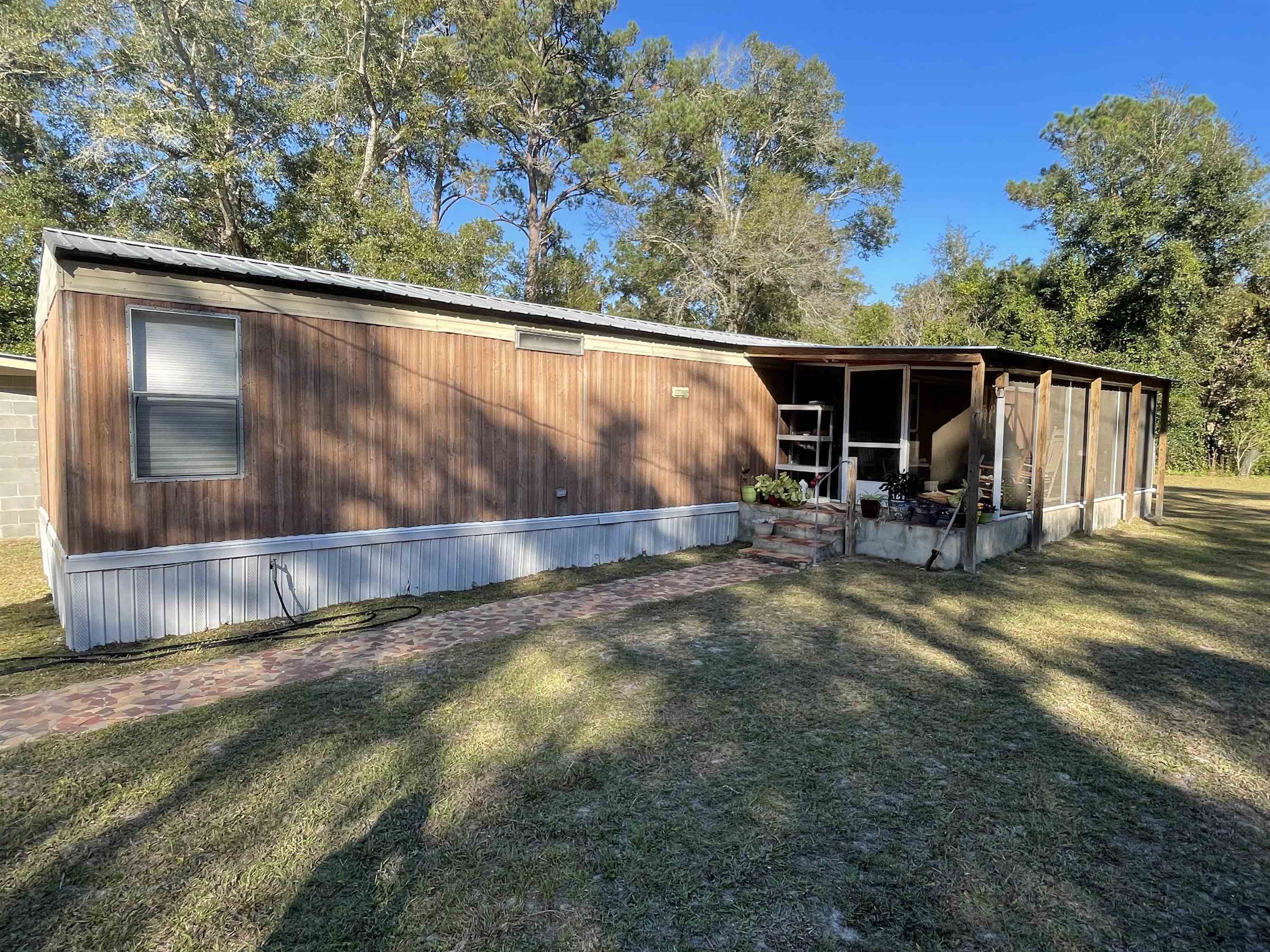 Are you looking for a peaceful and quite Neiborhood to call home? This is a one-of-a-kind property. The property comes fully furnished. A must see! The home is close to town and is 14 minutes from FSU's campus and shopping. The property sets just around the corner from Ochlocknee management area, where there are horse trails, hiking, hunting or nature watching. It also is right around the corner from Ochlocknee River boat ramp which will lead you to the world-famous Lake Talquin. The property also has a detached 4 car garage, with three garage doors and 1 open bay. The owner is putting in a new tile shower and will be done before closing. Property might be eligible for USDA loan 100% Financing.