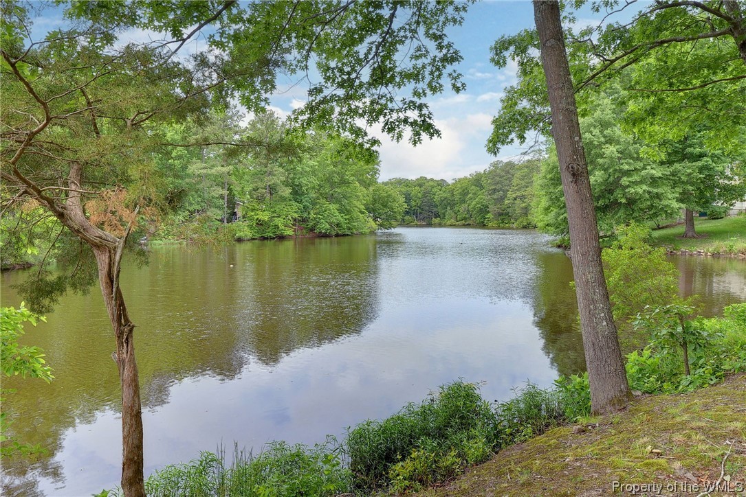Honoring the primary Tribe of the Powhatan Chiefdom, Lake Pasbehegh is the centerpiece of Williamsburg's First Colony community on the shore of the James River. This beautifully updated 3-br brick ranch takes its place on a spectacular 1-acre waterfront peninsula lot. Completely private from the street, the water's edge hugs the property with approx. 400 feet of frontage. Improvements since 2020 include a fully remodeled kitchen with new cabinets, island and level 7 granite tops, Cafe' counter depth French door refrigerator with hot water dispenser, Bosch dishwasher and new microwave, stove and washer and dryer. Also refinished red oak flooring, remodeled bathrooms, low E windows in the sunroom, new HVAC and whole house humidifier. See uploads for a complete list of features. First Colony has an optional owners association for access to the community beach, marina, clubhouse and pool, playground and sports fields.